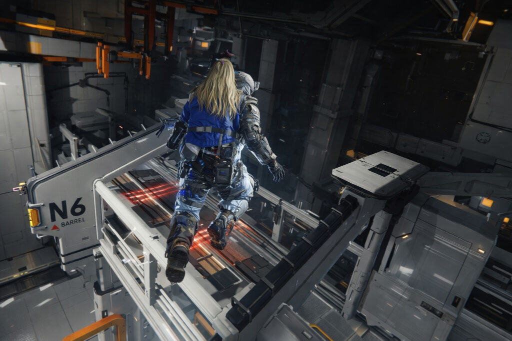 Action scene from Pragmata showing a space-suited soldier and a girl in a blue jacket running together along a narrow metal platform inside a futuristic industrial space station environment