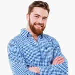 Friendly male team member in blue checkered shirt smiling